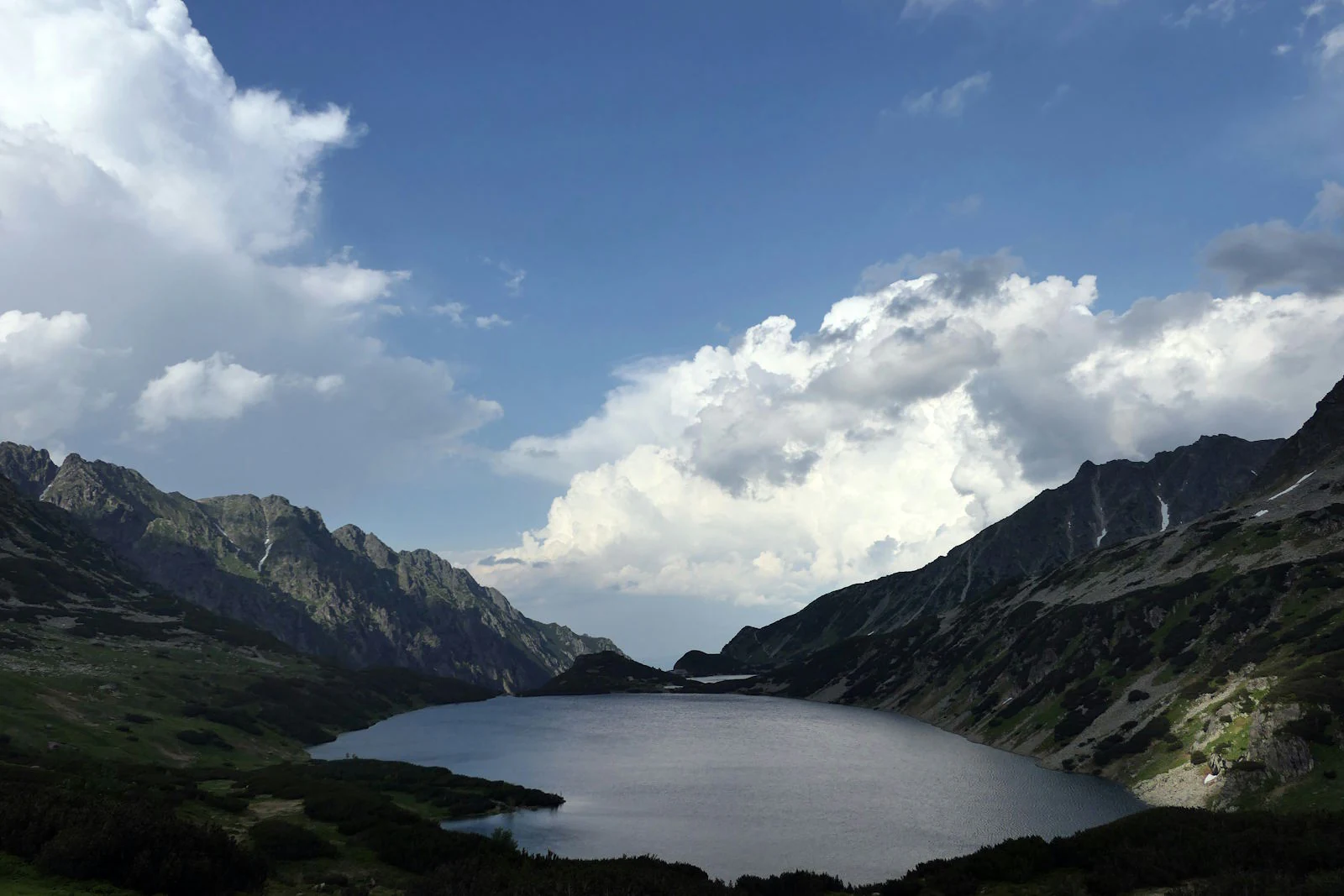 Mountain lake in the High Tatras, peaks against the light